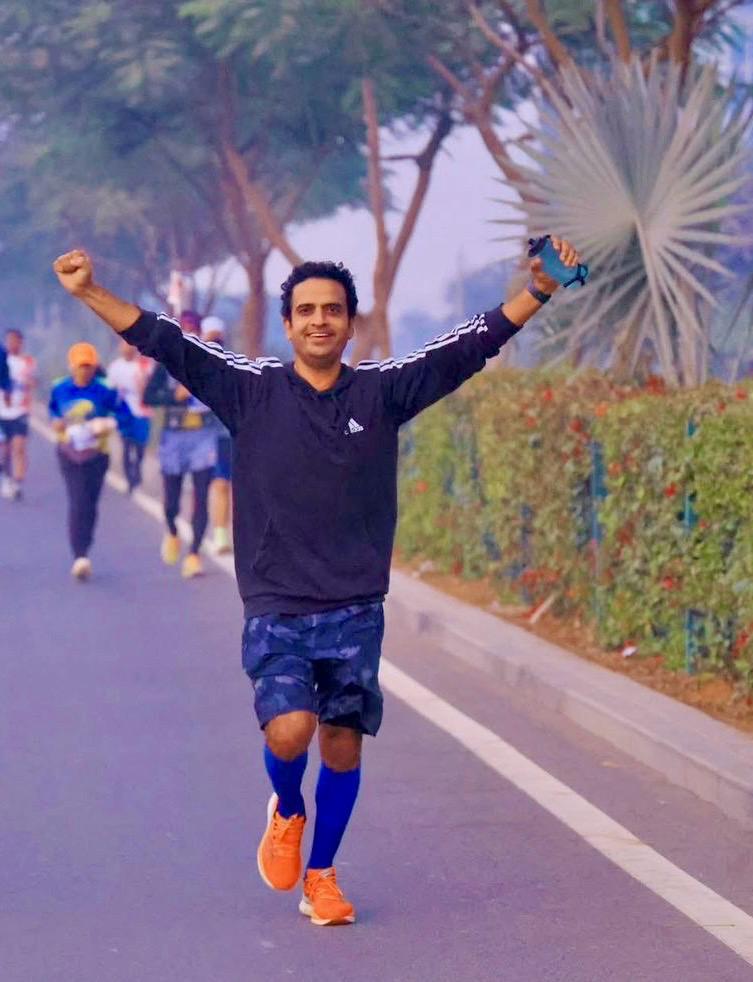 Vivek Sharma arms raised crossing a finish line, the joy of endurance racing