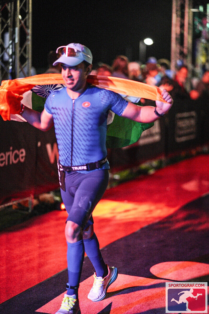 Vivek running down the finish chute at Ironman Western Australia with the Indian flag