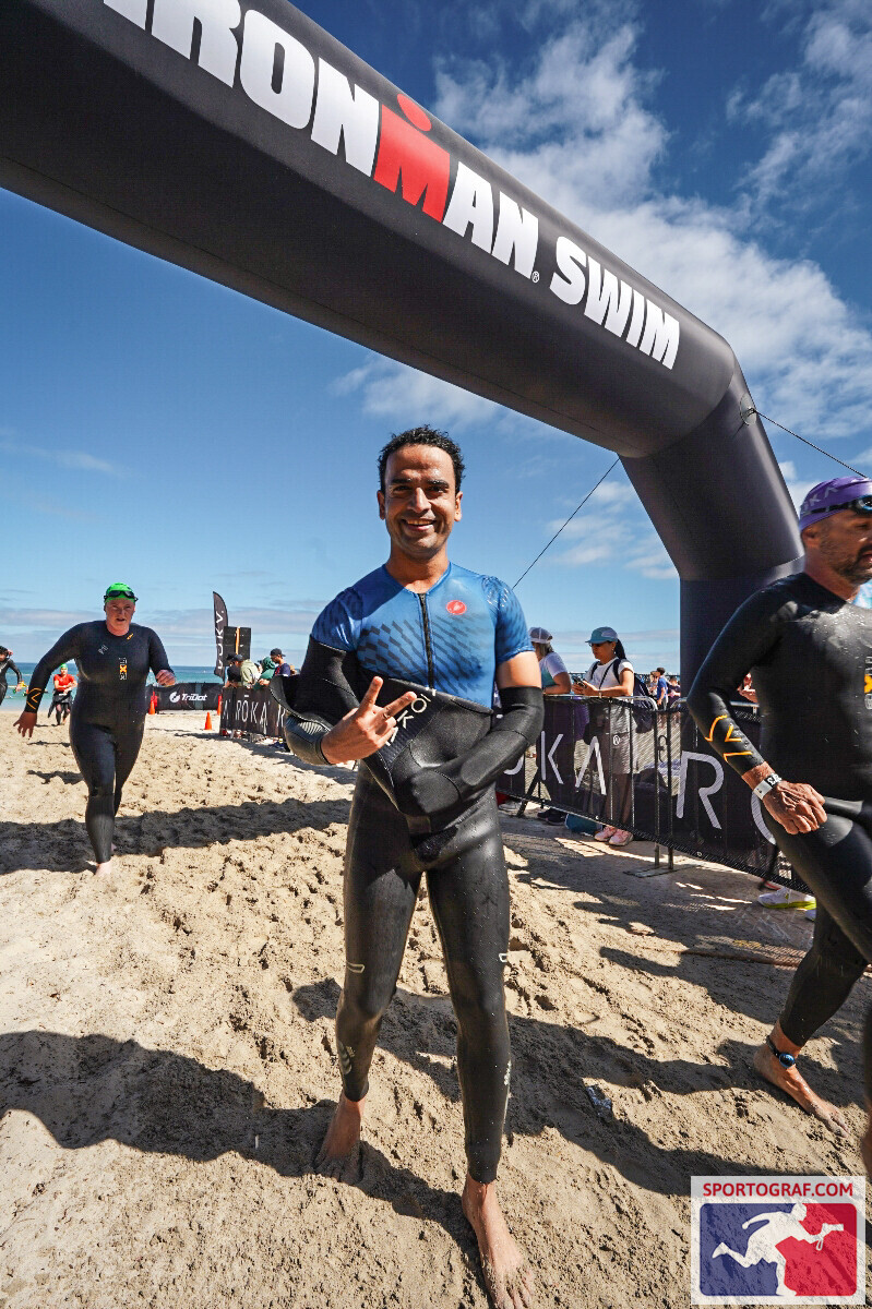 Vivek under the Ironman Swim arch after completing the 3.8km swim